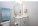 Simple bathroom with white vanity, toilet and a mirror at 14025 Kauai Dr, Orlando, FL 32827