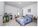 Charming bedroom with dinosaur bedding, a desk and a spacious closet at 14025 Kauai Dr, Orlando, FL 32827