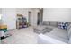 Spacious bonus room with sectional sofa and storage shelving at 14025 Kauai Dr, Orlando, FL 32827