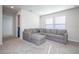 Spacious bonus room with L-shaped sectional sofa and carpet flooring at 14025 Kauai Dr, Orlando, FL 32827