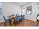 Dining room with a wooden table and blue chairs near a window and door at 14025 Kauai Dr, Orlando, FL 32827