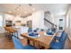 Open concept dining room with kitchen and staircase visible in the background at 14025 Kauai Dr, Orlando, FL 32827