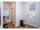 Light-filled entryway with hardwood floors and access to other rooms at 14025 Kauai Dr, Orlando, FL 32827