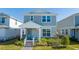 Two-story house with gray siding, white trim, and a covered porch at 14025 Kauai Dr, Orlando, FL 32827