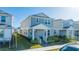 Two-story house with gray siding, white trim, and a covered porch at 14025 Kauai Dr, Orlando, FL 32827