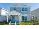 Two-story house with gray siding, white trim, and a covered porch at 14025 Kauai Dr, Orlando, FL 32827