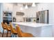 Modern kitchen with white cabinets, stainless steel appliances and quartz countertops at 14025 Kauai Dr, Orlando, FL 32827