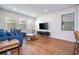 Bright living room featuring hardwood floors, comfortable sectional sofa, and stylish coffee table at 14025 Kauai Dr, Orlando, FL 32827