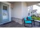 Covered porch with two teal chairs and a side table at 14025 Kauai Dr, Orlando, FL 32827