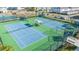 Two well-maintained tennis courts with seating and fencing at 14025 Kauai Dr, Orlando, FL 32827