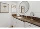 Elegant bathroom boasts a granite countertop, double vanity, and large mirror at 1641 Lake Baldwin Ln, Orlando, FL 32814