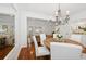 Elegant dining room with hardwood floors, a chandelier, and a round wooden table at 1641 Lake Baldwin Ln, Orlando, FL 32814