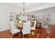 Open concept dining room with hardwood floors, chandelier, and view into living room at 1641 Lake Baldwin Ln, Orlando, FL 32814