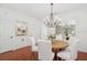 Bright dining room with hardwood floors, chandelier, and white chairs at 1641 Lake Baldwin Ln, Orlando, FL 32814