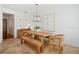 Bright dining room features a rustic wooden table with bench seating and a large statement art piece at 1641 Lake Baldwin Ln, Orlando, FL 32814