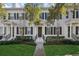 Three-unit townhome building with white exteriors and dark-colored doors at 1641 Lake Baldwin Ln, Orlando, FL 32814