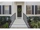 White exterior with black shutters and a dark-colored door at 1641 Lake Baldwin Ln, Orlando, FL 32814