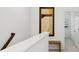 Upstairs hallway with neutral walls, wooden bench, and framed artwork at 1641 Lake Baldwin Ln, Orlando, FL 32814