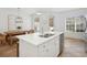 White kitchen with stainless steel appliances, island, and breakfast nook at 1641 Lake Baldwin Ln, Orlando, FL 32814