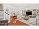 Spacious living room with hardwood floors, built-in shelving, and comfortable seating at 1641 Lake Baldwin Ln, Orlando, FL 32814