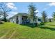 Covered patio, grassy yard, and playset at 1705 Bent Branch Ave, Deland, FL 32720