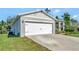 House exterior showcasing a white garage door and landscaping at 1705 Bent Branch Ave, Deland, FL 32720