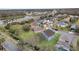 Aerial view showcasing a house's location in a residential neighborhood near a lake and road at 2556 Volta Cir, Kissimmee, FL 34746
