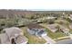 Aerial view of a two-story house with a large backyard and surrounding neighborhood at 2556 Volta Cir, Kissimmee, FL 34746