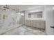 Luxury bathroom with double vanity, marble flooring and a large shower at 2556 Volta Cir, Kissimmee, FL 34746