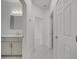 Bright bathroom with white cabinets and marble-look floors at 2556 Volta Cir, Kissimmee, FL 34746