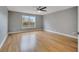 Light-filled bedroom with hardwood floors and large window at 2556 Volta Cir, Kissimmee, FL 34746