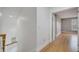 Upstairs hallway with hardwood floors and access to bedrooms at 2556 Volta Cir, Kissimmee, FL 34746