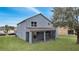 Two-story house with gray siding, screened patio, and a spacious lawn at 2556 Volta Cir, Kissimmee, FL 34746