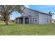 Two story house exterior with gray siding, screened porch and large yard at 2556 Volta Cir, Kissimmee, FL 34746