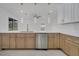 Modern kitchen with a large island and stainless steel dishwasher at 2556 Volta Cir, Kissimmee, FL 34746
