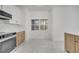 Eat-in kitchen with white cabinets and a window overlooking the yard at 2556 Volta Cir, Kissimmee, FL 34746