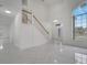 Spacious living room with high ceilings, marble floors, and a staircase at 2556 Volta Cir, Kissimmee, FL 34746