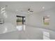 Bright living room with marble floors and sliding glass doors leading to the backyard at 2556 Volta Cir, Kissimmee, FL 34746