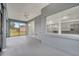 Bright screened porch with view of backyard and kitchen at 2556 Volta Cir, Kissimmee, FL 34746