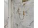 Luxurious shower with marble tile and gold fixtures at 2556 Volta Cir, Kissimmee, FL 34746