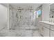 Large walk-in shower with marble tile and dual shower heads at 2556 Volta Cir, Kissimmee, FL 34746