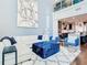 L-shaped sofa and blue velvet ottoman highlight this open living area at 260 S Osceola Ave # 1611, Orlando, FL 32801