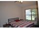 Bright bedroom with striped bedding, window, and ceiling fan at 2912 Squire Oak Ct, St Cloud, FL 34769