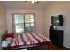 Comfortable bedroom with large window, flat-screen TV, and ample storage at 2912 Squire Oak Ct, St Cloud, FL 34769