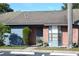 Brick condo front entrance with blue accents and landscaping at 2912 Squire Oak Ct, St Cloud, FL 34769