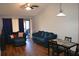 Living room with hardwood floors, blue couches and dining area at 2912 Squire Oak Ct, Saint Cloud, FL 34769