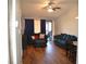 Living room with hardwood floors, blue couches, and dining area at 2912 Squire Oak Ct, St Cloud, FL 34769
