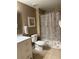 Well-lit bathroom featuring a new vanity, toilet, and shower with stylish curtain at 3006 Bonfire Beach Dr # 102, Kissimmee, FL 34746