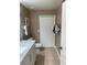 Bathroom featuring white cabinets, marble countertop, and a bifold closet door at 3006 Bonfire Beach Dr # 102, Kissimmee, FL 34746