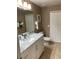 Bright bathroom featuring a marble vanity and large mirror at 3006 Bonfire Beach Dr # 102, Kissimmee, FL 34746